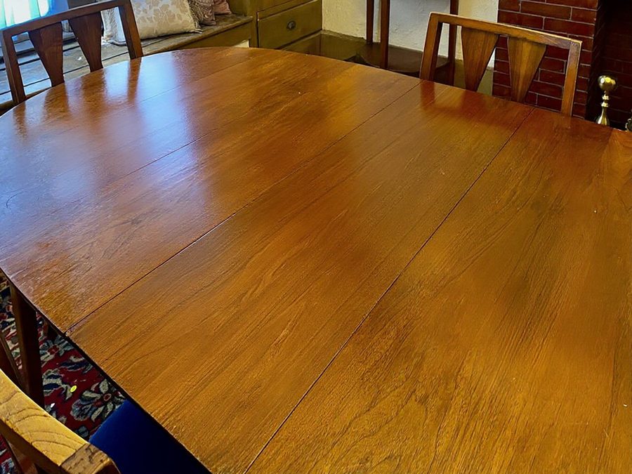 After: Remove all the food, plates, glasses, bottles and cutlery from the table; leave the bare wooden table and chairs.